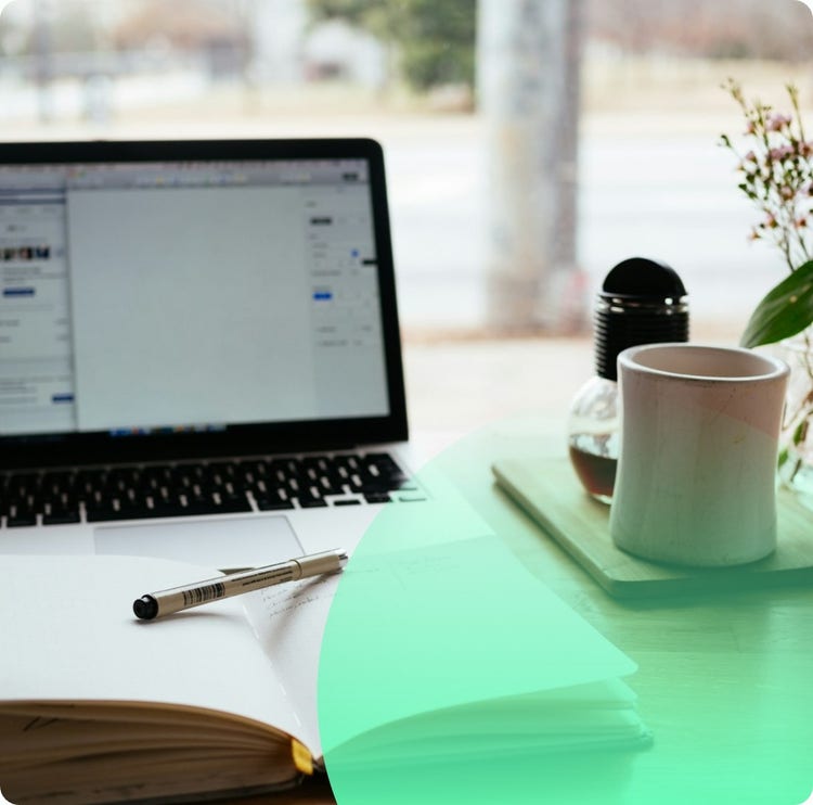 Laptop, notebook and coffee on a desk, ready for an online course